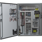 Open industrial electrical control panel with wires, circuit breakers, and switches, labeled with voltages.